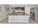 Bright kitchen features a large island with sink, stainless steel appliances, and granite countertops at 12712 Dusty Trail Dr, Sarasota, FL 34238
