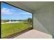 View from the screened lanai to community pond with well-manicured yard at 12712 Dusty Trail Dr, Sarasota, FL 34238