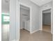 Laundry room with white washer and dryer, white storage shelf, and view of the front windows at 12712 Dusty Trail Dr, Sarasota, FL 34238