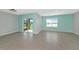 Spacious living room with sliding glass doors leading to outdoor living space and a large window at 12712 Dusty Trail Dr, Sarasota, FL 34238