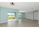 Spacious living room with sliding glass doors leading to outdoor living space and a large window at 12712 Dusty Trail Dr, Sarasota, FL 34238