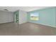 Spacious living room with sliding glass doors leading to outdoor living space and a large window at 12712 Dusty Trail Dr, Sarasota, FL 34238