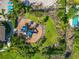 Aerial shot of playground featuring blue play structures, mature palms, and lush vegetation with a fenced perimeter at 12712 Dusty Trail Dr, Sarasota, FL 34238