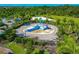 Aerial view of a splash pad with lounge chairs, landscaping, and a black metal fence at 12712 Dusty Trail Dr, Sarasota, FL 34238