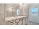 Bathroom featuring double sink vanity with granite countertop and a view to the bedroom window at 12728 Lateral Root Dr, Sarasota, FL 34238