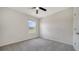 Carpeted bedroom with a ceiling fan and a bright window at 12728 Lateral Root Dr, Sarasota, FL 34238
