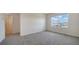 Bright carpeted bedroom features a large window with a neighborhood view at 12728 Lateral Root Dr, Sarasota, FL 34238