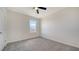 Carpeted bedroom with a window and door to the hallway at 12728 Lateral Root Dr, Sarasota, FL 34238
