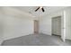 This bedroom features neutral walls, grey carpet, and a ceiling fan at 12728 Lateral Root Dr, Sarasota, FL 34238