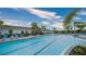 Long community pool with lane lines and ample lounge seating in a tropical setting at 12728 Lateral Root Dr, Sarasota, FL 34238