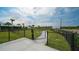 Small dog park with a black fence, grassy area, and walkway at 12728 Lateral Root Dr, Sarasota, FL 34238