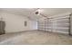 Spacious two car garage with concrete flooring, water heater, and automatic garage door at 12728 Lateral Root Dr, Sarasota, FL 34238