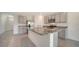 Kitchen island featuring granite counters, gray cabinets, and stainless steel appliances at 12728 Lateral Root Dr, Sarasota, FL 34238