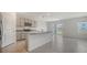 Modern kitchen with stainless steel appliances, granite countertops, and tile flooring; sliding door to backyard at 12728 Lateral Root Dr, Sarasota, FL 34238