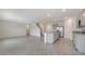 Open-concept kitchen with an island, stainless steel appliances, tile flooring, and seamless flow to living area at 12728 Lateral Root Dr, Sarasota, FL 34238