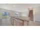 Open kitchen with granite countertops, stainless appliances, and tile flooring at 12728 Lateral Root Dr, Sarasota, FL 34238