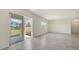 Bright living room boasts tile floors, sliding glass doors, and large windows at 12728 Lateral Root Dr, Sarasota, FL 34238