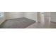 Open-concept living space featuring neutral walls, plush carpeting, tile flooring, and ample natural light at 12728 Lateral Root Dr, Sarasota, FL 34238