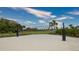 Community sand volleyball court with net and open green space at 12728 Lateral Root Dr, Sarasota, FL 34238