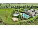 Aerial view of community pool, playgrounds, and courts in the Promenade Estates neighborhood at 12732 Lateral Root Dr, Sarasota, FL 34238