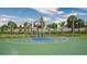 Outdoor basketball court with lush landscaping and palm trees for recreational enjoyment at 12732 Lateral Root Dr, Sarasota, FL 34238