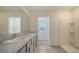 Bathroom featuring double sinks, granite countertops, and a tiled floor at 12732 Lateral Root Dr, Sarasota, FL 34238