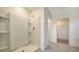 Bathroom with a tiled shower and tiled floors; view to walk-in closet at 12732 Lateral Root Dr, Sarasota, FL 34238