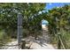 Picturesque beach path lined with lush greenery, leading to soft sands and tranquil waters at 12732 Lateral Root Dr, Sarasota, FL 34238
