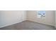 Bedroom featuring neutral carpeting, light-colored walls, baseboards, and natural light from a window at 12732 Lateral Root Dr, Sarasota, FL 34238
