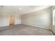 The bedroom has neutral carpeting and baseboards, with a doorway to the en suite bathroom at 12732 Lateral Root Dr, Sarasota, FL 34238
