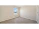 Cozy bedroom with plush carpeting and ample natural light from the window at 12732 Lateral Root Dr, Sarasota, FL 34238