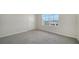 Bedroom with gray carpet and large window to the outside at 12732 Lateral Root Dr, Sarasota, FL 34238