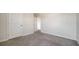 Simple bedroom with neutral walls and soft gray carpet at 12732 Lateral Root Dr, Sarasota, FL 34238