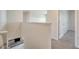 Upstairs hallway featuring neutral walls, plush carpet, and views of the kitchen below at 12732 Lateral Root Dr, Sarasota, FL 34238