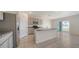 Well-equipped kitchen features an island with granite countertops and stainless-steel appliances at 12732 Lateral Root Dr, Sarasota, FL 34238