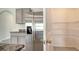 Kitchen with stainless steel refrigerator and ample pantry storage space at 12732 Lateral Root Dr, Sarasota, FL 34238