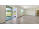 Open living room with tile floors, sliding glass doors to the backyard, and a bright, airy feel at 12732 Lateral Root Dr, Sarasota, FL 34238