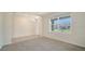 Bright, naturally lit room featuring tile flooring and a large window with a view of the outdoors at 12732 Lateral Root Dr, Sarasota, FL 34238