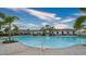 Community pool with palm trees and seating area in the Promenade Estates neighborhood at 12732 Lateral Root Dr, Sarasota, FL 34238
