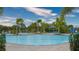 A pristine pool with lounge chairs and palm trees create a relaxing oasis at 12732 Lateral Root Dr, Sarasota, FL 34238