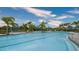 Community pool with zero entry, lounge chairs, palm trees and splash park at 12732 Lateral Root Dr, Sarasota, FL 34238