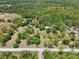 Beautiful aerial view of country land featuring lush greenery, serene ponds, and quiet streets at 13719 Seminole Trl, Wimauma, FL 33598