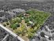 Aerial view of property lines on land with a lush pond, serene landscape, and tranquil wooded areas at 13719 Seminole Trl, Wimauma, FL 33598