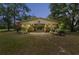 Charming barn featuring a well-kept structure, surrounded by lush greenery and an open design at dusk at 13719 Seminole Trl, Wimauma, FL 33598