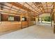 Spacious barn interior with wooden stalls, high ceilings, and ample natural light for livestock and storage at 13719 Seminole Trl, Wimauma, FL 33598