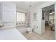 Bathroom with retro fixtures, shower-tub combo, glass block window, and tile floor at 13719 Seminole Trl, Wimauma, FL 33598