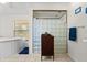Bathroom featuring a glass block shower with a vintage cabinet for storage at 13719 Seminole Trl, Wimauma, FL 33598