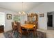 Elegant dining room with a large wooden table, chandelier, and a patterned area rug at 13719 Seminole Trl, Wimauma, FL 33598