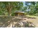 Wide exterior of this lovely home surrounded by beautiful trees and greenery at 13719 Seminole Trl, Wimauma, FL 33598