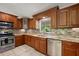 A modern kitchen with stainless steel appliances, granite countertops, and stylish tile backsplash at 13719 Seminole Trl, Wimauma, FL 33598